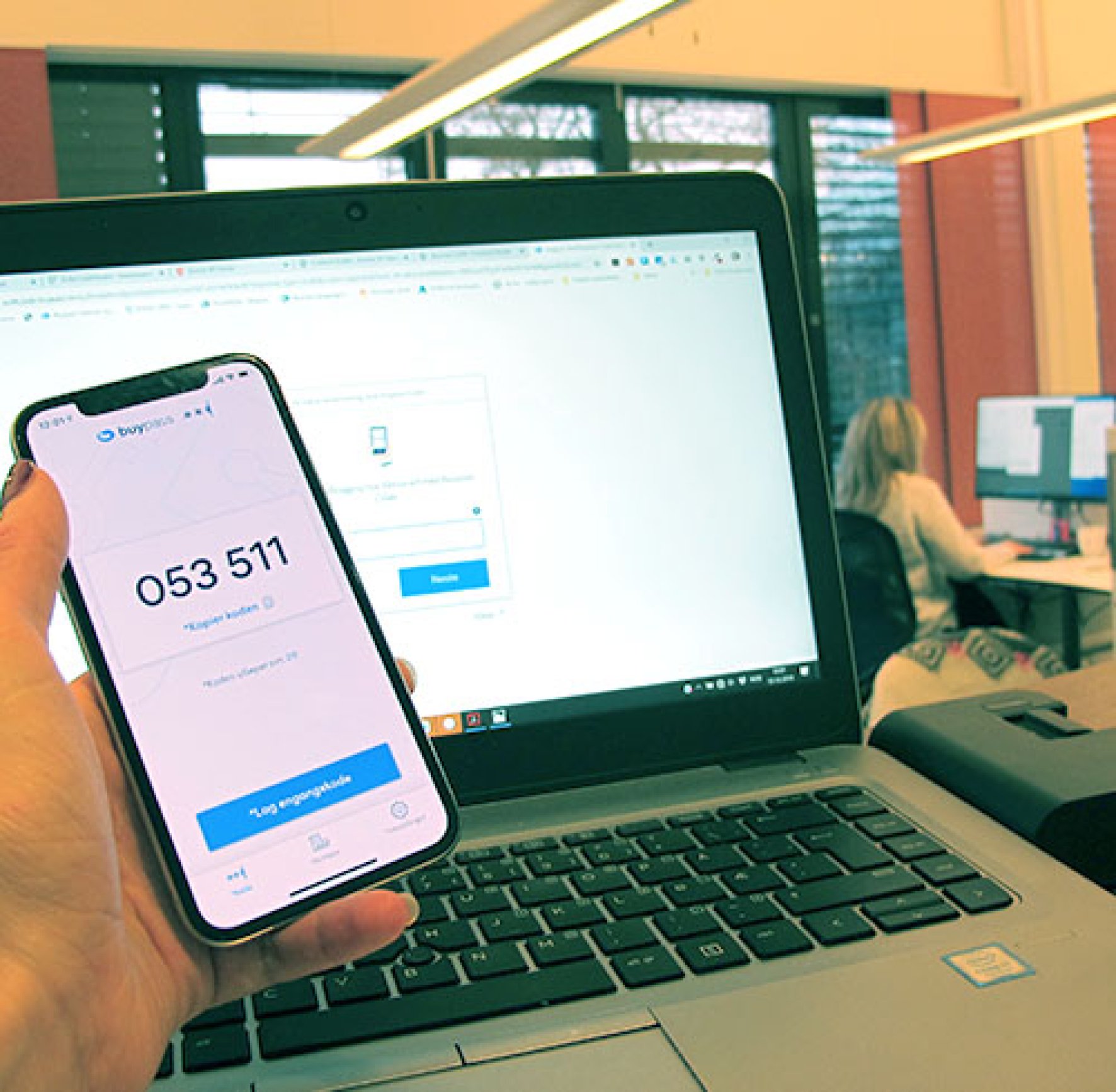 Hand holding mobile phone with Buypass Code app in use Hand holding mobile phone with Buypass Code app in use