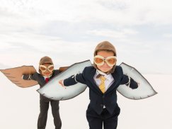 Children in suits with wings and glasses. Ready to fly.